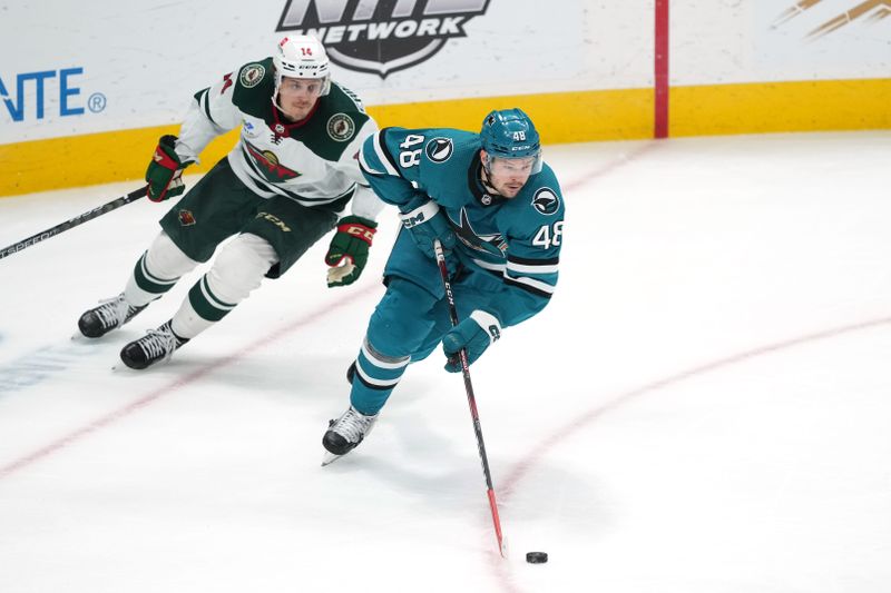 Mar 11, 2023; San Jose, California, USA; San Jose Sharks center Tomas Hertl (48) skates with the puck against Minnesota Wild center Joel Eriksson Ek (14) during the third period at SAP Center at San Jose. Mandatory Credit: Darren Yamashita-USA TODAY Sports