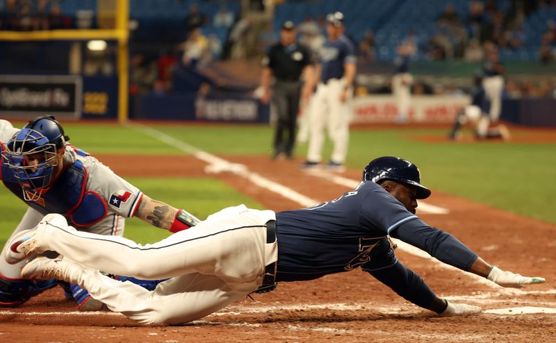 Apr 2, 2024; St. Petersburg, Florida, USA; Texas Rangers catcher Jonah Heim (28) tags out Tampa Bay Rays outfielder Randy Arozarena (56) during the eighth inning at Tropicana Field. Mandatory Credit: Kim Klement Neitzel-USA TODAY Sports