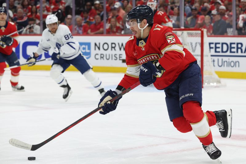 May 11, 2025; Sunrise, Florida, USA; Florida Panthers center Evan Rodrigues (17) skates with the puck against the Toronto Maple Leafs during the first period in game four of the second round of the 2025 Stanley Cup Playoffs at Amerant Bank Arena. Mandatory Credit: Kim Klement Neitzel-Imagn Images