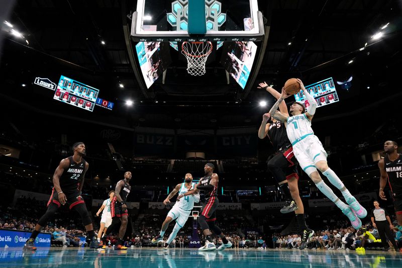 CHARLOTTE, NORTH CAROLINA - OCTOBER 08: LaMelo Ball #1 of the Charlotte Hornets goes to the basket against Nikola Jovic #5 of the Miami Heat during the first half of the preseason game at Spectrum Center on October 08, 2024 in Charlotte, North Carolina. NOTE TO USER: User expressly acknowledges and agrees that, by downloading and or using this photograph, User is consenting to the terms and conditions of the Getty Images License Agreement. (Photo by Grant Halverson/Getty Images)