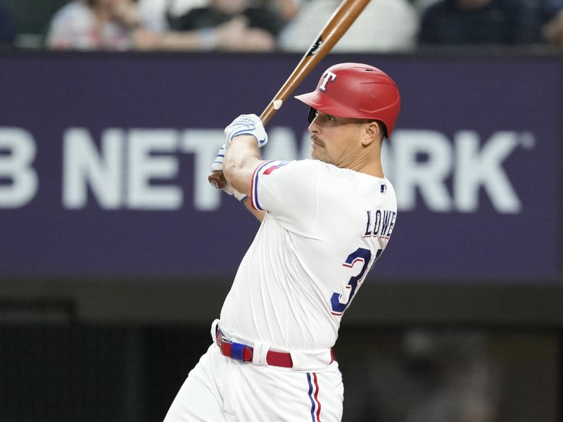 Jun 27, 2023; Arlington, Texas, USA; Texas Rangers first baseman Nathaniel Lowe (30) follows through on his RBI single against the Detroit Tigers during the eighth inning at Globe Life Field. Mandatory Credit: Jim Cowsert-USA TODAY Sports