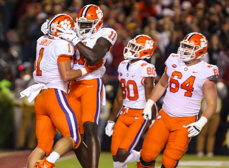 Nov 27, 2021; Columbia, South Carolina, USA; Clemson Tigers running back Will Shipley (1) and Clemson Tigers wide receiver Ajou Ajou (11) celebrate a Shipley touchdowns against the South Carolina Gamecocks in the first quarter at Williams-Brice Stadium. Mandatory Credit: Jeff Blake-USA TODAY Sports