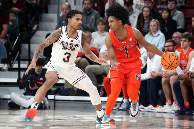 Jan 27, 2024; Starkville, Mississippi, USA; Auburn Tigers guard Aden Holloway (1) dribbles as Mississippi State Bulldogs guard Shakeel Moore (3) defends during the second half at Humphrey Coliseum. Mandatory Credit: Petre Thomas-USA TODAY Sports