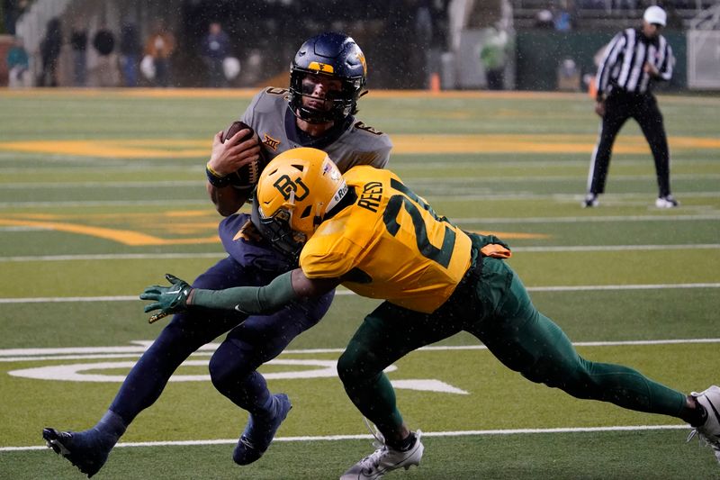 Nov 25, 2023; Waco, Texas, USA; West Virginia Mountaineers quarterback Garrett Greene (6) is tackled by Baylor Bears cornerback Chateau Reed (21) during the first half at McLane Stadium. Mandatory Credit: Raymond Carlin III-USA TODAY Sports