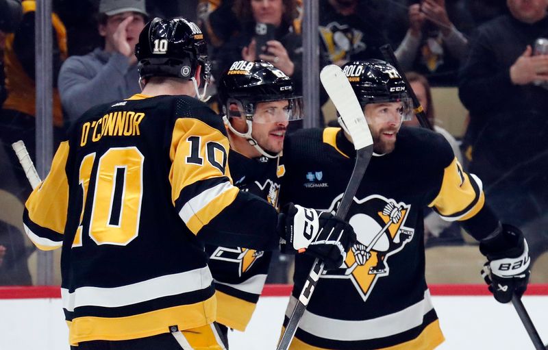 Apr 6, 2024; Pittsburgh, Pennsylvania, USA;  Pittsburgh Penguins center Sidney Crosby (middle) celebrates with left wing Drew O'Connor (10) and right wing Bryan Rust (17) after scoring a goal against the Tampa Bay Lightning during the first period at PPG Paints Arena. Mandatory Credit: Charles LeClaire-USA TODAY Sports