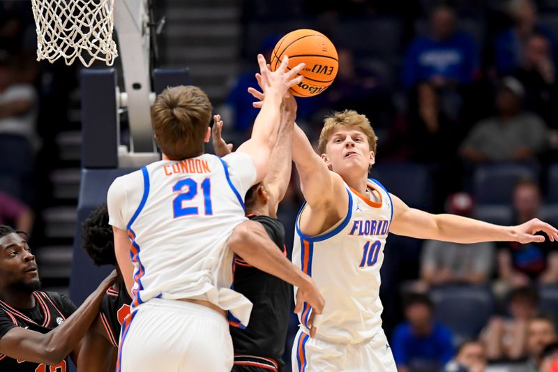 Mar 14, 2024; Nashville, TN, USA;  Florida Gators forward Alex Condon (21) and forward Thomas Haugh (10) fight for the rebound against the Georgia Bulldogs during the first half at Bridgestone Arena. Mandatory Credit: Steve Roberts-USA TODAY Sports