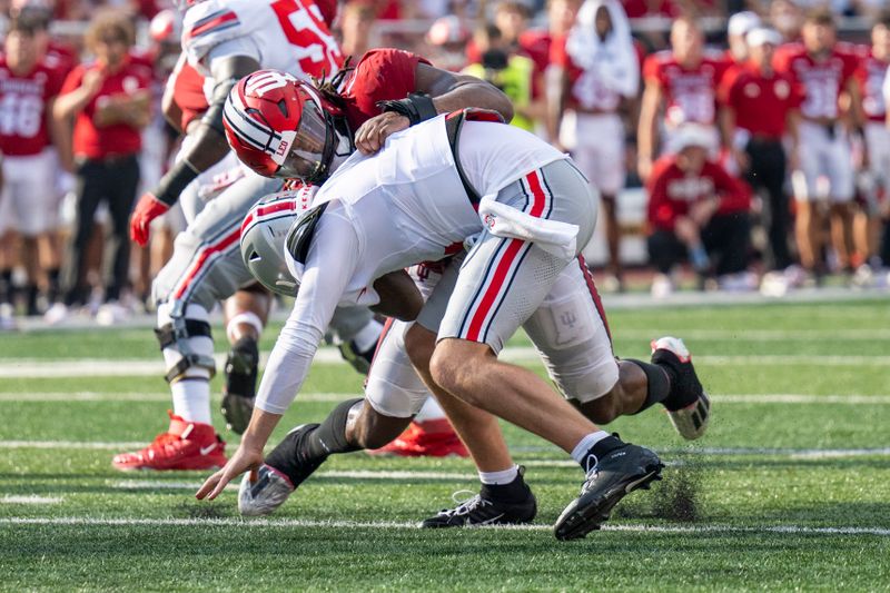 Sep 2, 2023; Bloomington, Indiana, USA; Indiana Hoosiers defensive lineman Andre Carter (1) tackles Ohio State Buckeyes quarterback Kyle McCord (6) during the second half at Memorial Stadium. Mandatory Credit: Marc Lebryk-USA TODAY Sports