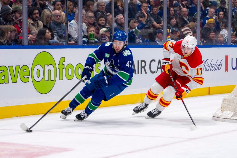 Apr 16, 2024; Vancouver, British Columbia, CAN; Calgary Flames forward Yegor Sharangovich (17) pursues Vancouver Canucks defenseman Quinn Hughes (43) in the second period at Rogers Arena. Mandatory Credit: Bob Frid-USA TODAY Sports