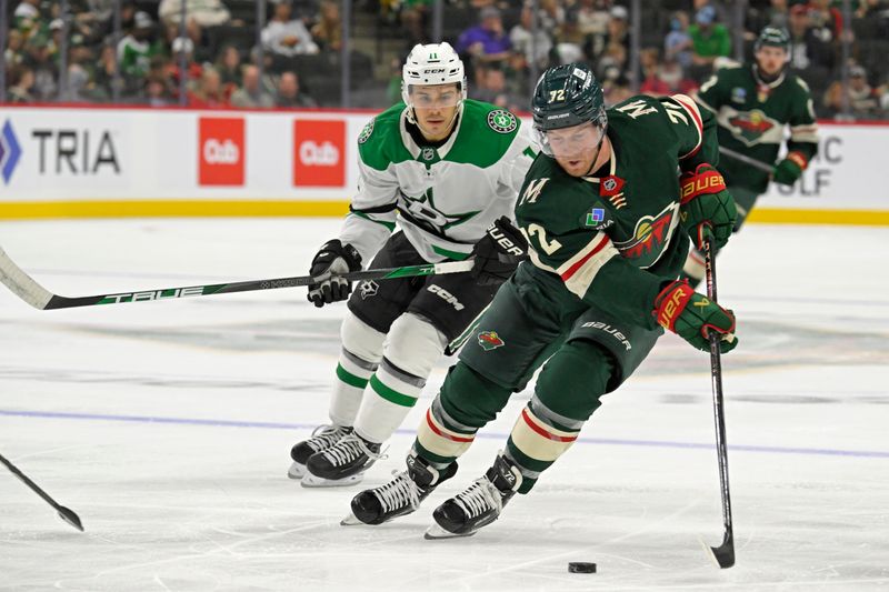 Sep 29, 2024; Saint Paul, Minnesota, USA;  Minnesota Wild forward Travis Boyd (72) controls the puck as Dallas Stars forward Logan Stankoven (11) gives chase during the second period at Xcel Energy Center. Mandatory Credit: Nick Wosika-Imagn Images