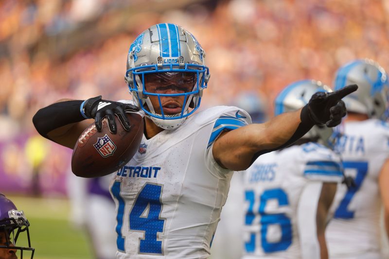 Detroit Lions wide receiver Amon-Ra St. Brown (14) signals a first down against the Minnesota Vikings during the second half of an NFL football game Sunday, Oct. 20, 2024, in Minneapolis. (AP Photo/Bruce Kluckhohn)