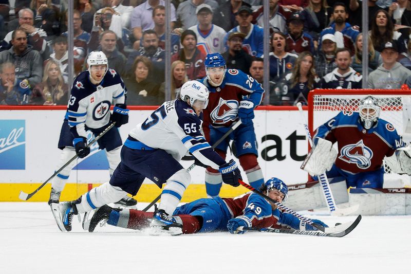 Apr 26, 2024; Denver, Colorado, USA; Colorado Avalanche defenseman Samuel Girard (49) slides for the puck against Winnipeg Jets center Mark Scheifele (55) in the second period in game three of the first round of the 2024 Stanley Cup Playoffs at Ball Arena. Mandatory Credit: Isaiah J. Downing-USA TODAY Sports