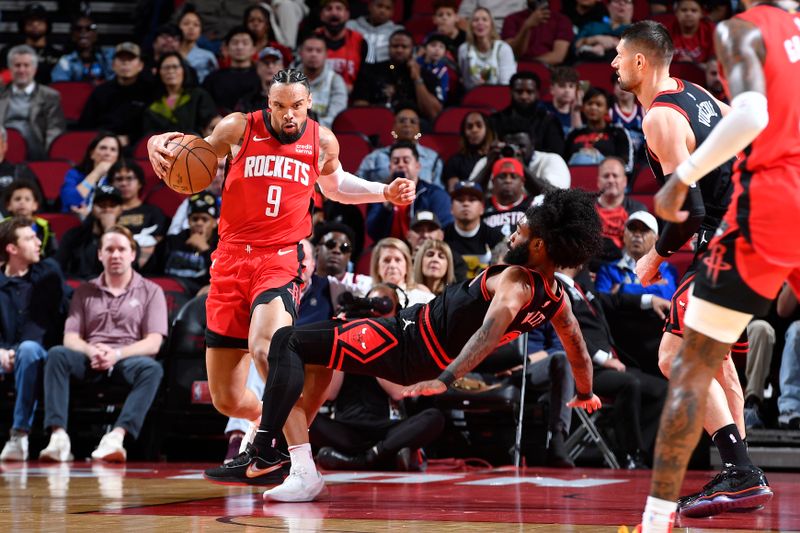 HOUSTON, TX - MARCH 21:   Dillon Brooks #9 of the Houston Rockets handles the ball during the game as Coby White #0 of the Chicago Bulls plays defense on March 21, 2024 at the Toyota Center in Houston, Texas. NOTE TO USER: User expressly acknowledges and agrees that, by downloading and or using this photograph, User is consenting to the terms and conditions of the Getty Images License Agreement. Mandatory Copyright Notice: Copyright 2024 NBAE (Photo by Logan Riely/NBAE via Getty Images)