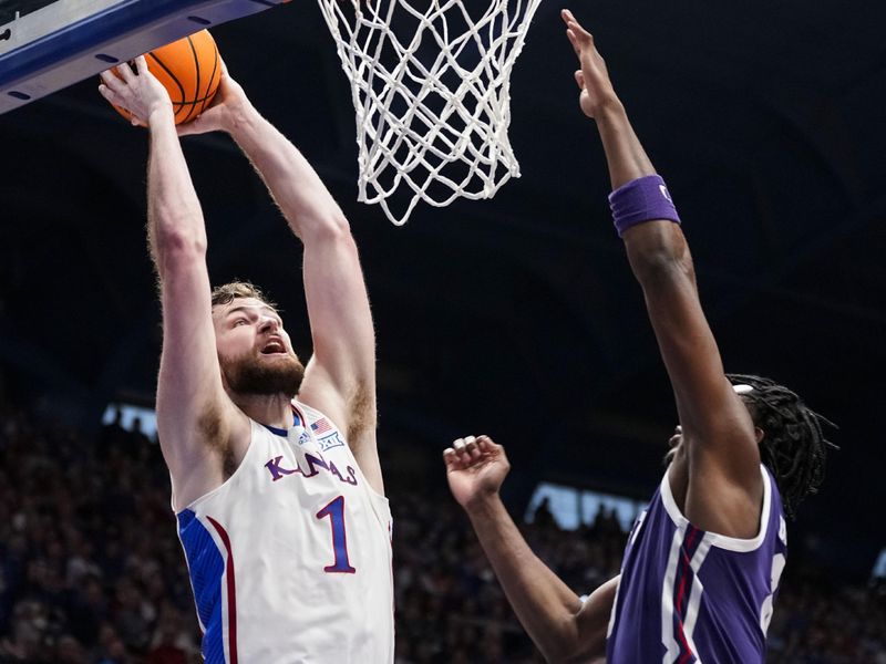 Jan 6, 2024; Lawrence, Kansas, USA; Kansas Jayhawks center Hunter Dickinson (1) dunks the ball against TCU Horned Frogs center Ernest Udeh Jr. (8) during the second half at Allen Fieldhouse. Mandatory Credit: Jay Biggerstaff-USA TODAY Sports