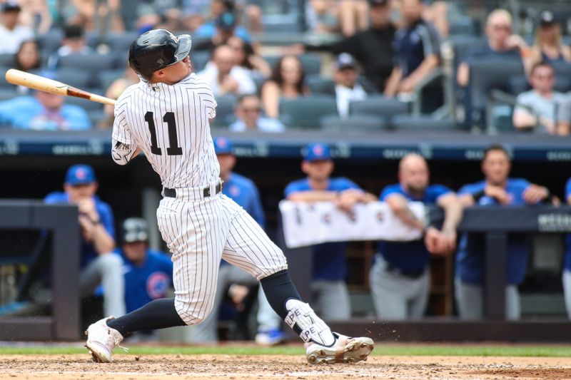 Jul 9, 2023; Bronx, New York, USA;  New York Yankees shortstop Anthony Volpe (11) hits a two-run home run in the sixth inning against the Chicago Cubs at Yankee Stadium. Mandatory Credit: Wendell Cruz-USA TODAY Sports