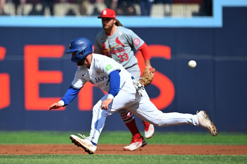 Sep 15, 2024; Toronto, Ontario, CAN;  Toronto Blue Jays left fielder Davis Schneider (36) runs past St. Louis Cardinals second baseman Brendan Donovan (33) before being thrown out trying to steal second base in the second inning at Rogers Centre. Mandatory Credit: Dan Hamilton-Imagn Images