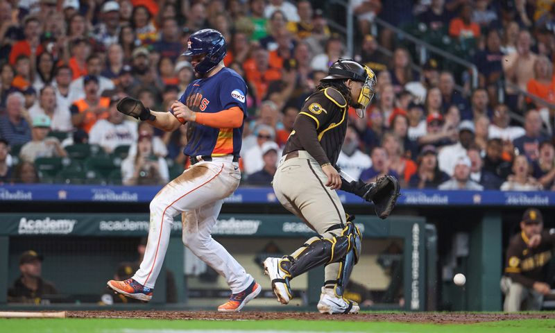 Sep 10, 2023; Houston, Texas, USA; Houston Astros center fielder Chas McCormick (20) scores a run after en error by San Diego Padres catcher Luis Campusano (12) during the sixth inning at Minute Maid Park. Mandatory Credit: Troy Taormina-USA TODAY Sports