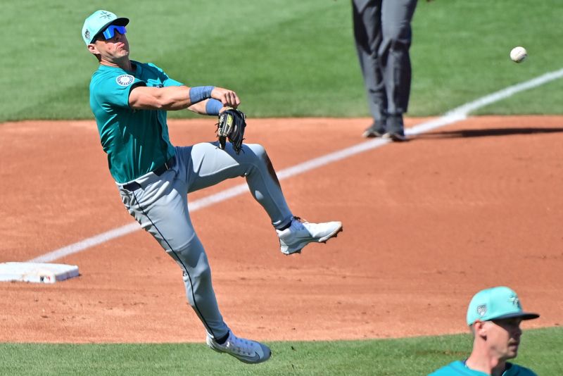 Mar 8, 2024; Mesa, Arizona, USA;  Seattle Mariners third baseman Dylan Moore (25) throws to first base in the second inning against the Chicago Cubs  during a spring training game at Sloan Park. Mandatory Credit: Matt Kartozian-USA TODAY Sports