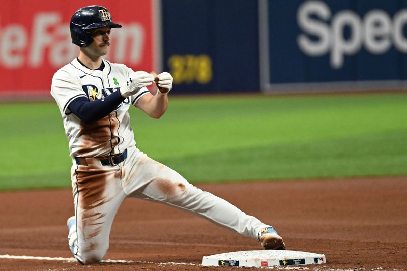 May 29, 2024; St. Petersburg, Florida, USA; Tampa Bay Rays second baseman Brandon Lowe (8) reacts after hitting a RBI triple  in the fourth inning against the Oakland Athletics  at Tropicana Field. Mandatory Credit: Jonathan Dyer-USA TODAY Sports