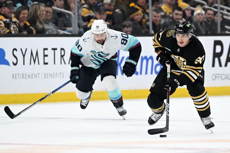 Feb 15, 2024; Boston, Massachusetts, USA; Boston Bruins center Anthony Richard (90) skates against Seattle Kraken left wing Tomas Tatar (90) during the first period at TD Garden. Mandatory Credit: Brian Fluharty-USA TODAY Sports