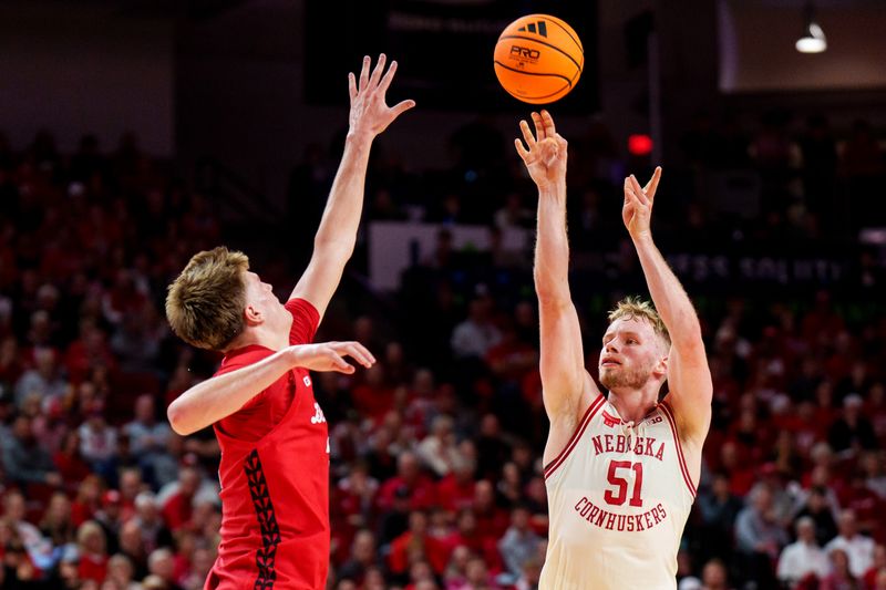 Dec 10, 2025; Lincoln, Nebraska, USA; Nebraska Cornhuskers forward Rienk Mast (51) shoots a three point basket against Wisconsin Badgers forward Nolan Winter (31) during the first half at Pinnacle Bank Arena. Mandatory Credit: Dylan Widger-Imagn Images