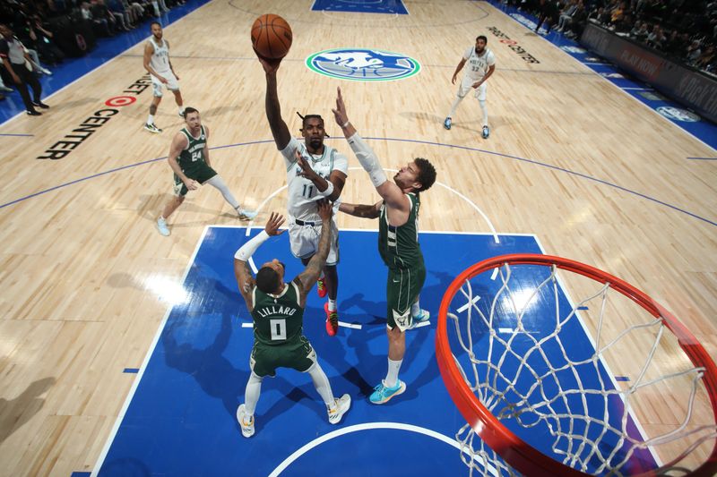 MINNEAPOLIS, MN -  FEBRUARY 23: Naz Reid #11 of the Minnesota Timberwolves drives to the basket during the game against the Milwaukee Bucks on February 23, 2024 at Target Center in Minneapolis, Minnesota. NOTE TO USER: User expressly acknowledges and agrees that, by downloading and or using this Photograph, user is consenting to the terms and conditions of the Getty Images License Agreement. Mandatory Copyright Notice: Copyright 2024 NBAE (Photo by Jordan Johnson/NBAE via Getty Images)