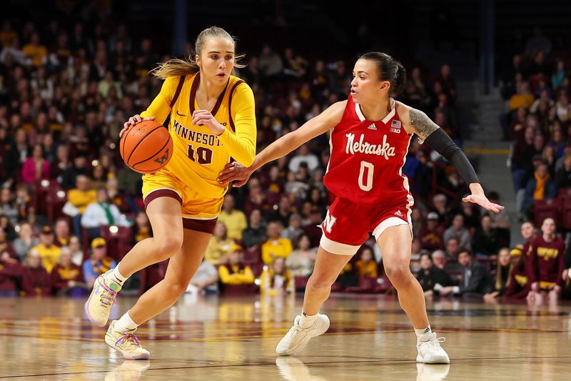 Jan 14, 2024; Minneapolis, Minnesota, USA; Minnesota Golden Gophers guard Mara Braun (10) works towards the basket as Nebraska Cornhuskers guard Darian White (0) defends during the first half at Williams Arena. Mandatory Credit: Matt Krohn-USA TODAY Sports