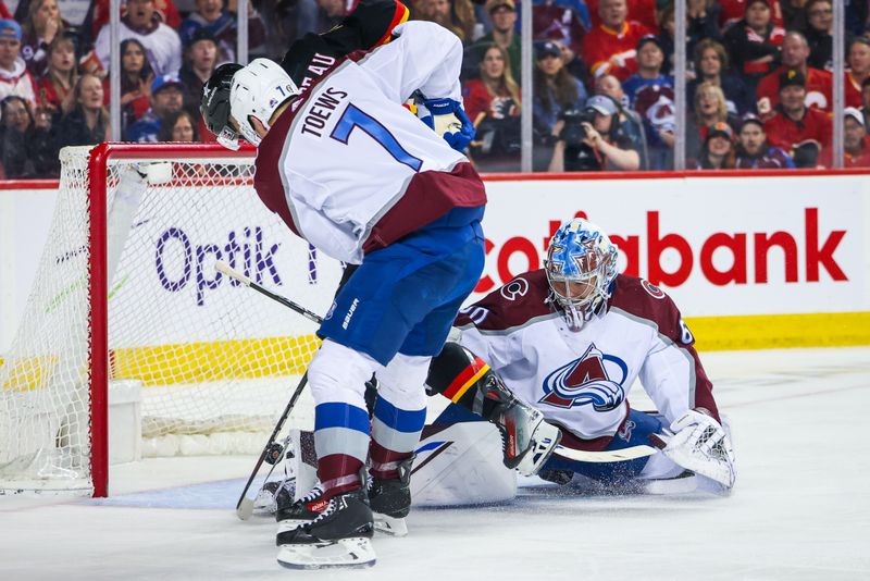 Mar 12, 2024; Calgary, Alberta, CAN; Colorado Avalanche goaltender Justus Annunen (60) makes a save against Calgary Flames center Jonathan Huberdeau (10) during the second period at Scotiabank Saddledome. Mandatory Credit: Sergei Belski-USA TODAY Sports