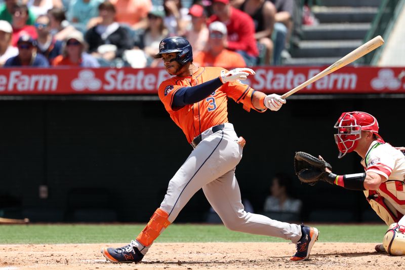 Jun 9, 2024; Anaheim, California, USA;  Houston Astros shortstop Jeremy Pena (3) hits an RBI single during the third inning against the Los Angeles Angels at Angel Stadium. Mandatory Credit: Kiyoshi Mio-USA TODAY Sports