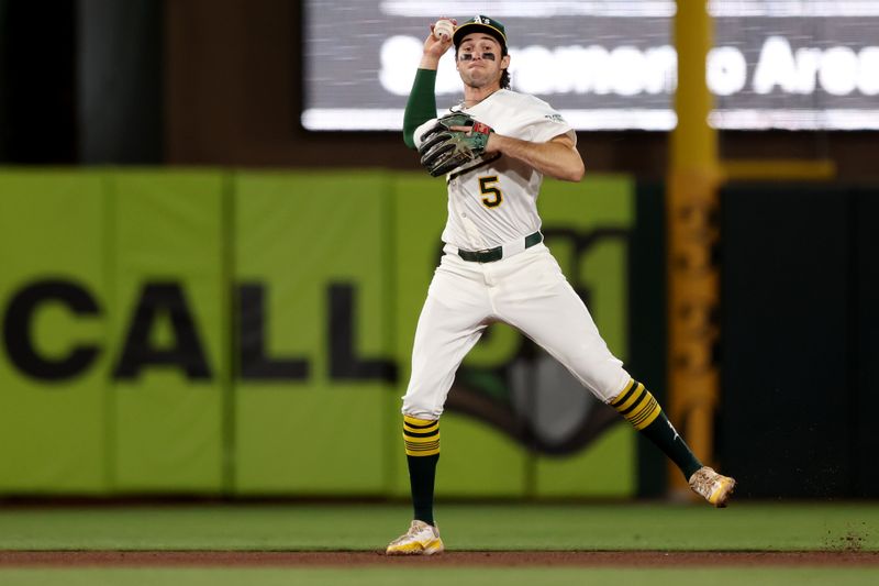 May 23, 2025; West Sacramento, California, USA; Athletics shortstop Jacob Wilson (5) throws to first against the Philadelphia Phillies during the ninth inning at Sutter Health Park. Mandatory Credit: Dennis Lee-Imagn Images