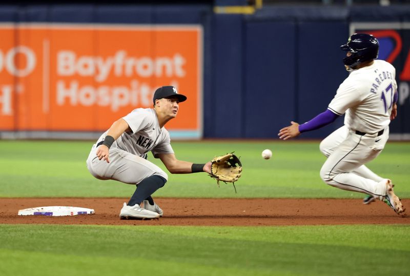 May 10, 2024; St. Petersburg, Florida, USA;  New York Yankees shortstop Anthony Volpe (11) tags out Tampa Bay Rays third base Isaac Paredes (17) as he attempted to steal second base during the seventh inning at Tropicana Field. Mandatory Credit: Kim Klement Neitzel-USA TODAY Sports