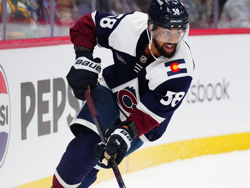 Feb 28, 2025; Denver, Colorado, USA; Colorado Avalanche defenseman Oliver Kylington (58) controls the puck in the third period against the Minnesota Wild at Ball Arena. Mandatory Credit: Ron Chenoy-Imagn Images