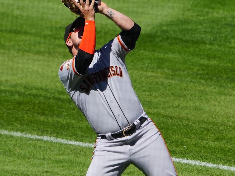 Sep 17, 2023; Denver, Colorado, USA;  San Francisco Giants third baseman J.D. Davis (7) fields the ball in the fifth inning against the Colorado Rockies at Coors Field. Mandatory Credit: Ron Chenoy-USA TODAY Sports