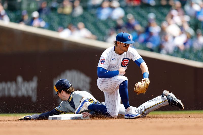 May 3, 2024; Chicago, Illinois, USA; Milwaukee Brewers third baseman Tyler Black (7) steals second base against Chicago Cubs second baseman Nico Hoerner (2) during the first inning at Wrigley Field. Mandatory Credit: Kamil Krzaczynski-USA TODAY Sports