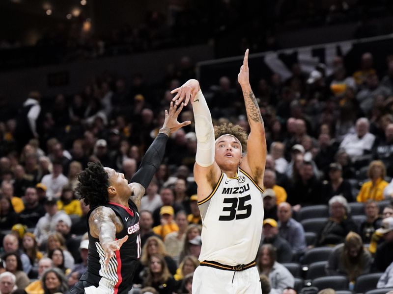 Jan 6, 2024; Columbia, Missouri, USA; Missouri Tigers forward Noah Carter (35) shoots a three point shot as Georgia Bulldogs guard Justin Hill (11) defends during the first half at Mizzou Arena. Mandatory Credit: Denny Medley-USA TODAY Sports