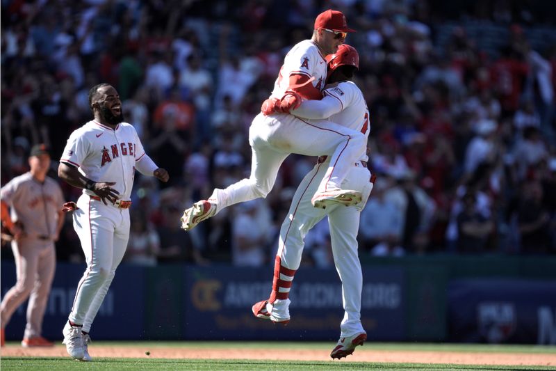Apr 20, 2025; Anaheim, California, USA; Los Angeles Angels center fielder Jo Adell (7) celebrates with catcher Logan O'Hoppe (14) after hitting a walk-off double against the San Francisco Giants at Angel Stadium. Mandatory Credit: Kirby Lee-Imagn Images