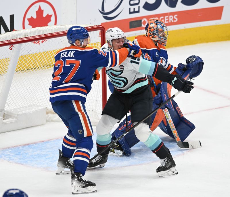 Mar 22, 2025; Edmonton, Alberta, CAN;  Edmonton Oilers defenceman Brett Kulak (27) and Seattle Kraken centre John Hayden (15) get mixed up in front of Edmonton Oilers goalie Stuart Skinner (74) during the first period at Rogers Place. Mandatory Credit: Walter Tychnowicz-Imagn Images