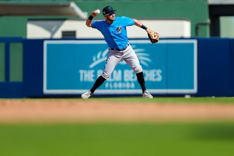 Mar 2, 2023; West Palm Beach, Florida, USA; Miami Marlins second baseman Garrett Hampson (1) throws to first base for an out against the Washington Nationals third during the fifth inning at The Ballpark of the Palm Beaches. Mandatory Credit: Sam Navarro-USA TODAY Sports