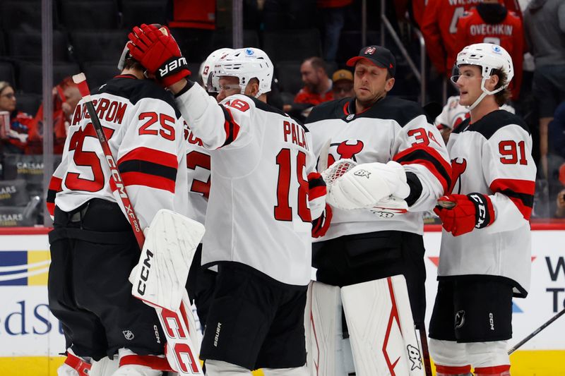 Oct 12, 2024; Washington, District of Columbia, USA; New Jersey Devils goaltender Jacob Markstrom (25) celebrates with teammates after their game against the Washington Capitals at Capital One Arena. Mandatory Credit: Geoff Burke-Imagn Images