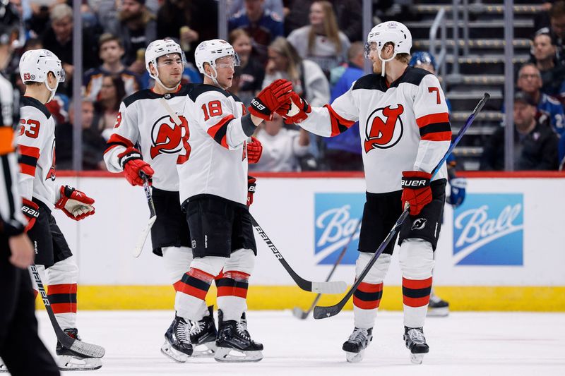 Nov 7, 2023; Denver, Colorado, USA; New Jersey Devils defenseman Dougie Hamilton (7) celebrates his goal with left wing Ondrej Palat (18) in the second period against the Colorado Avalanche at Ball Arena. Mandatory Credit: Isaiah J. Downing-USA TODAY Sports