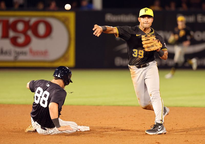 Mar 15, 2024; Tampa, Florida, USA; Pittsburgh Pirates second baseman Nick Gonzales (39) forces out New York Yankees catcher Austin Wells (88) and throws the ball to first base for a double play during the fifth inning at George M. Steinbrenner Field. Mandatory Credit: Kim Klement Neitzel-USA TODAY Sports