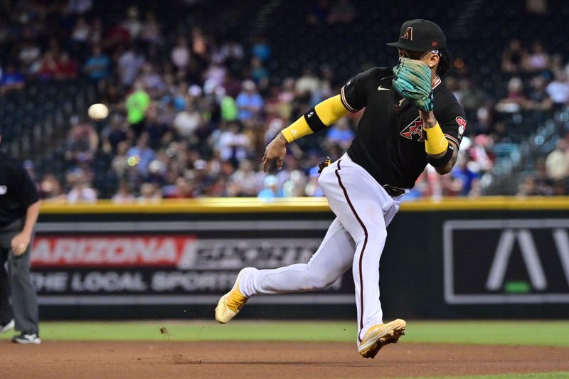 Apr 26, 2023; Phoenix, Arizona, USA; Arizona Diamondbacks second baseman Ketel Marte (4) fields a ground ball in the seventh inning against the Kansas City Royals at Chase Field. Mandatory Credit: Matt Kartozian-USA TODAY Sports