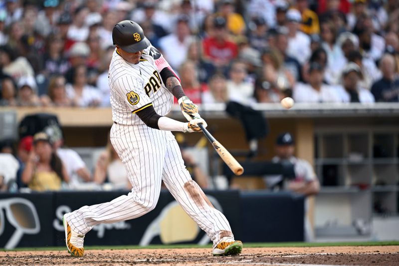 Jul 13, 2024; San Diego, California, USA; San Diego Padres designated hitter Manny Machado (13) hits a home run against the Atlanta Braves during the eighth inning at Petco Park. Mandatory Credit: Orlando Ramirez-USA TODAY Sports 