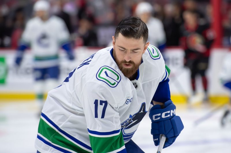 Nov 23, 2024; Ottawa, Ontario, CAN; Vancouver Canucks defenseman Filip Hronek (17) skates with the puck during warmup prior to game against the Ottawa Senators at the Canadian Tire Centre. Mandatory Credit: Marc DesRosiers-Imagn Images