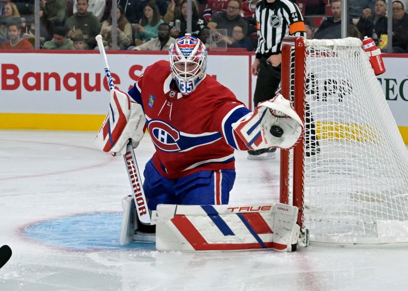 Sep 24, 2024; Montreal, Quebec, CAN; Montreal Canadiens goalie Sam Montembeault (35) makes a glove save against the New Jersey Devils during the second period at the Bell Centre. Mandatory Credit: Eric Bolte-Imagn Images