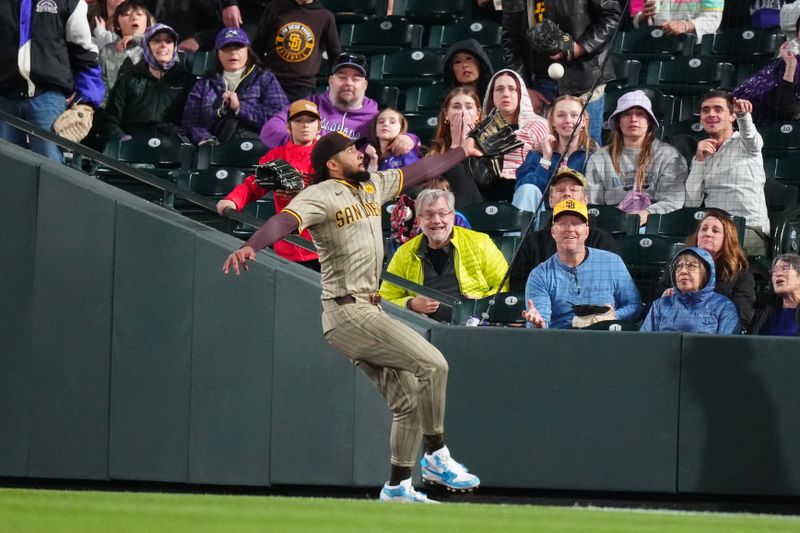 Apr 23, 2024; Denver, Colorado, USA; San Diego Padres outfielder Fernando Tatis Jr. (23) is unable to field a ball in the fifth inning against the Colorado Rockies at Coors Field. Mandatory Credit: Ron Chenoy-USA TODAY Sports