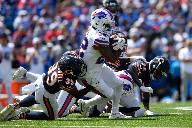 Buffalo Bills running back Ray Davis (22) is tackled by Chicago Bears' Josh Blackwell (39) during the first half of an preseason NFL football game, Saturday, Aug. 10, 2024, in Orchard Park, NY. (AP Photo/Adrian Kraus)