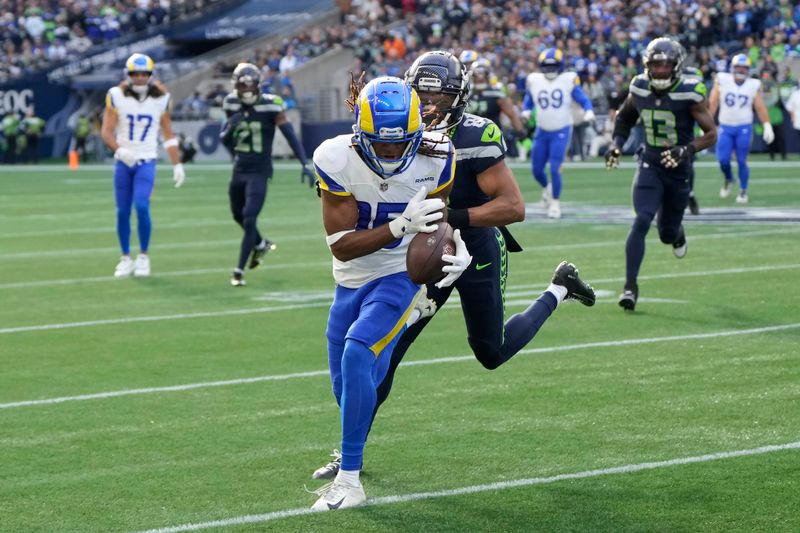 Los Angeles Rams wide receiver Demarcus Robinson, foreground, catches a pass in front of Seattle Seahawks cornerback Coby Bryant (8) during the first half of an NFL football game in Seattle, Sunday, Nov. 3, 2024. (AP Photo/Stephen Brashear)