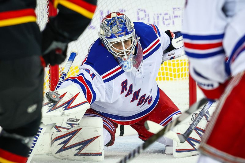 Nov 21, 2024; Calgary, Alberta, CAN; New York Rangers goaltender Igor Shesterkin (31) makes a save against the Calgary Flames during the second period at Scotiabank Saddledome. Mandatory Credit: Sergei Belski-Imagn Images