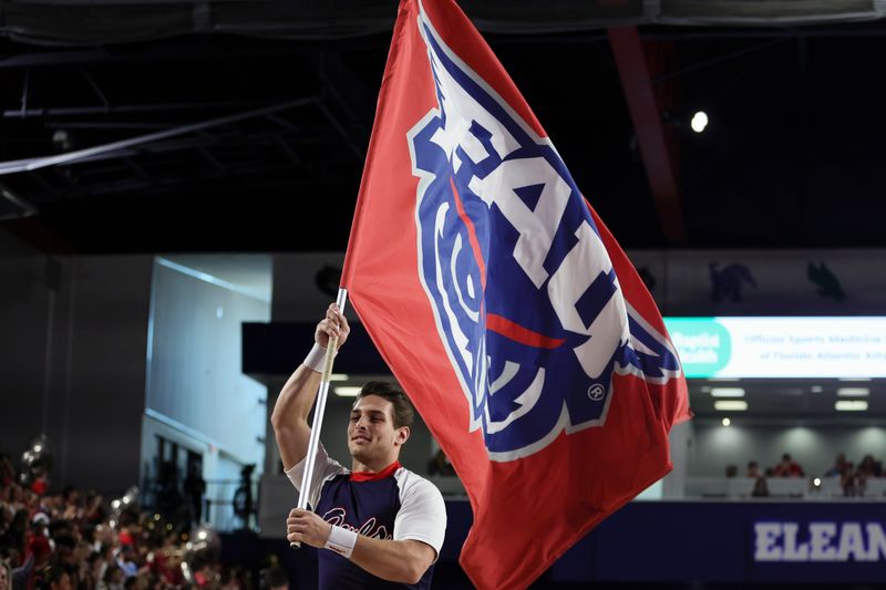 Jan 28, 2024; Boca Raton, Florida, USA; A cheerleader for the Florida Atlantic Owls waves a school flag prior to the game against the North Texas Mean Green at Eleanor R. Baldwin Arena. Mandatory Credit: Sam Navarro-USA TODAY Sports