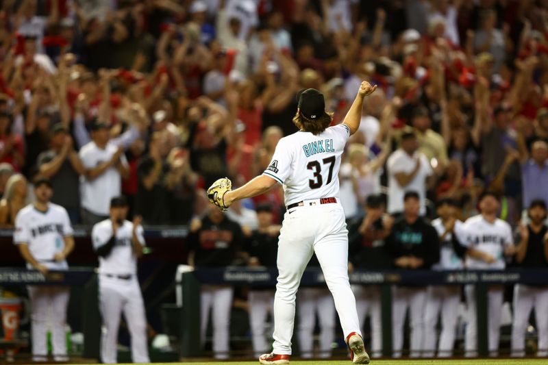 Oct 11, 2023; Phoenix, Arizona, USA; Arizona Diamondbacks relief pitcher Kevin Ginkel (37) reacts after an out against the Los Angeles Dodgers in the seventh inning for game three of the NLDS for the 2023 MLB playoffs at Chase Field. Mandatory Credit: Mark J. Rebilas-USA TODAY Sports